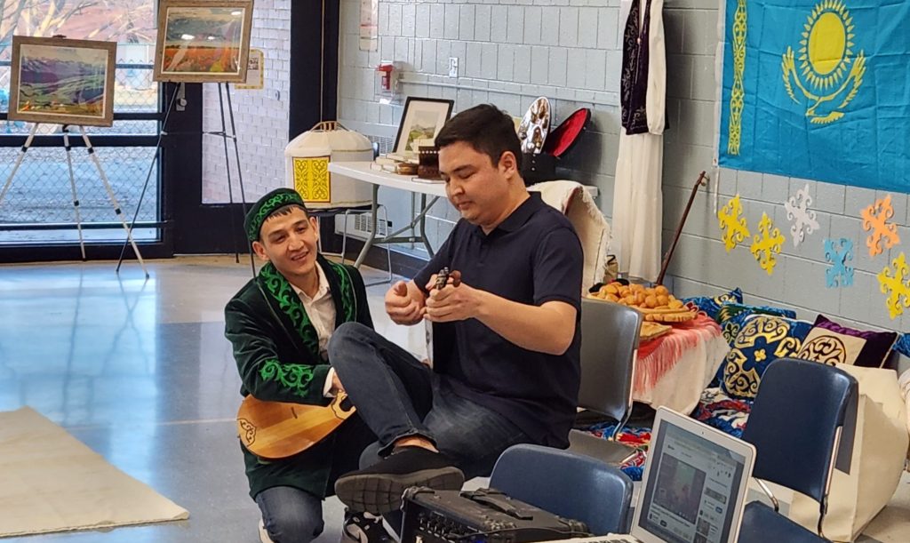 A Kazakh student plays the dombra.