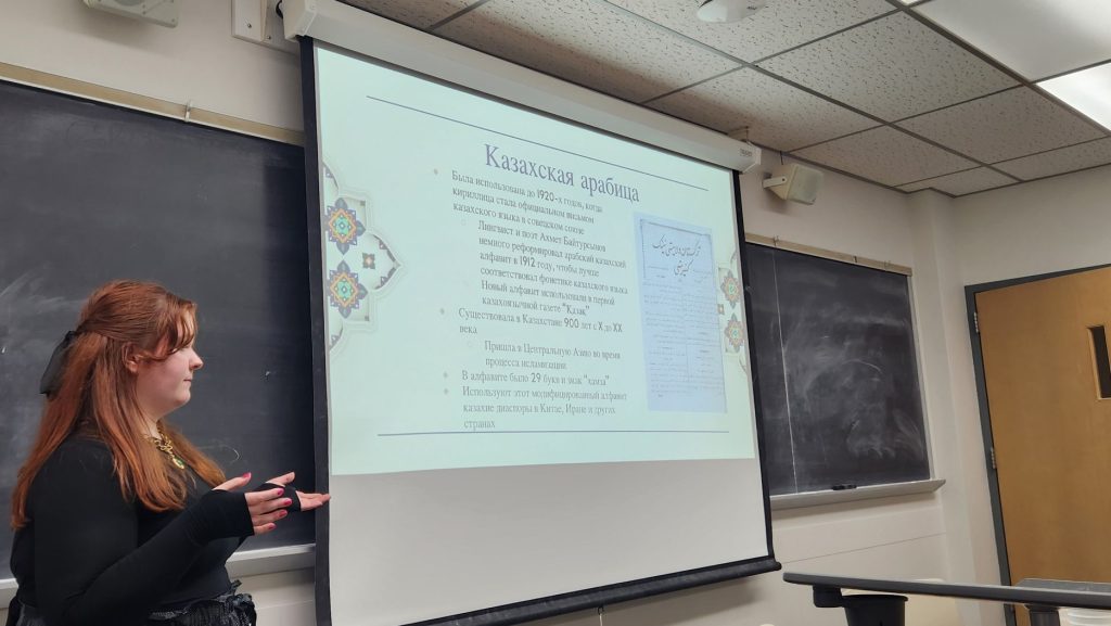 A student gives a presentation in Russian.